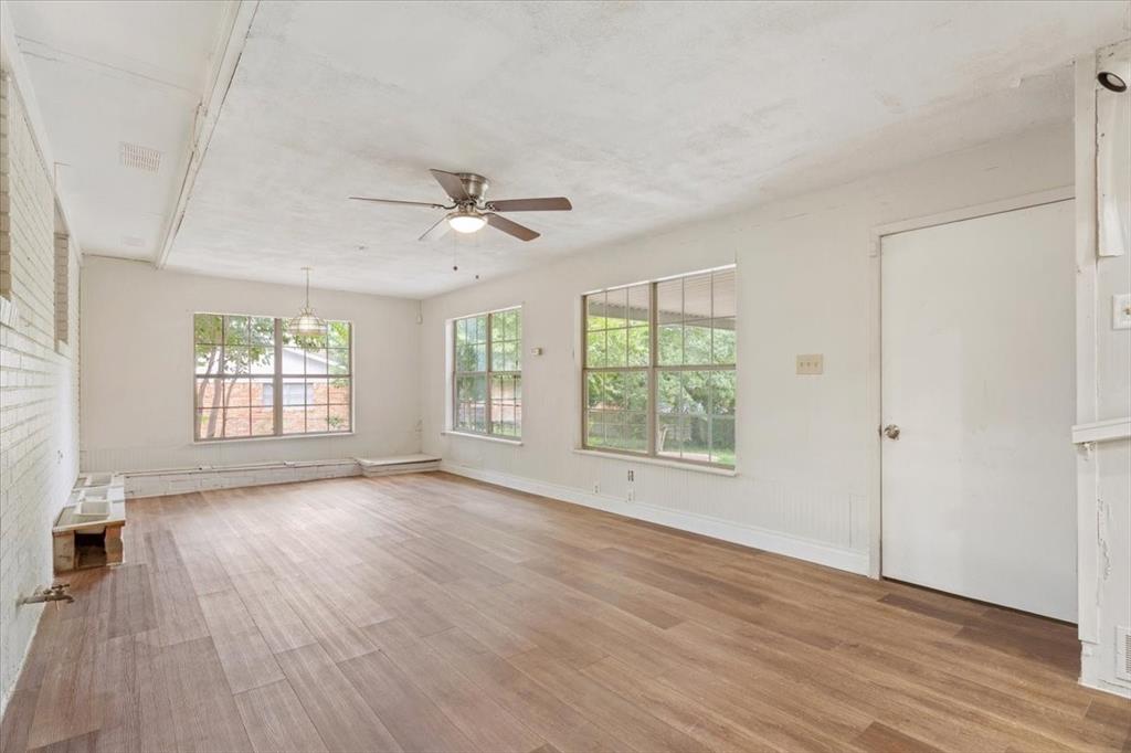849 Arlington Drive Woodway, TX 76712 - Photo 15 of 33 a view of an empty room with wooden floor and a window
