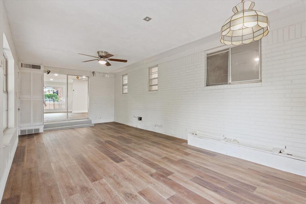 849 Arlington Drive Woodway, TX 76712 - Photo 16 of 33 wooden floor in an empty room with a window