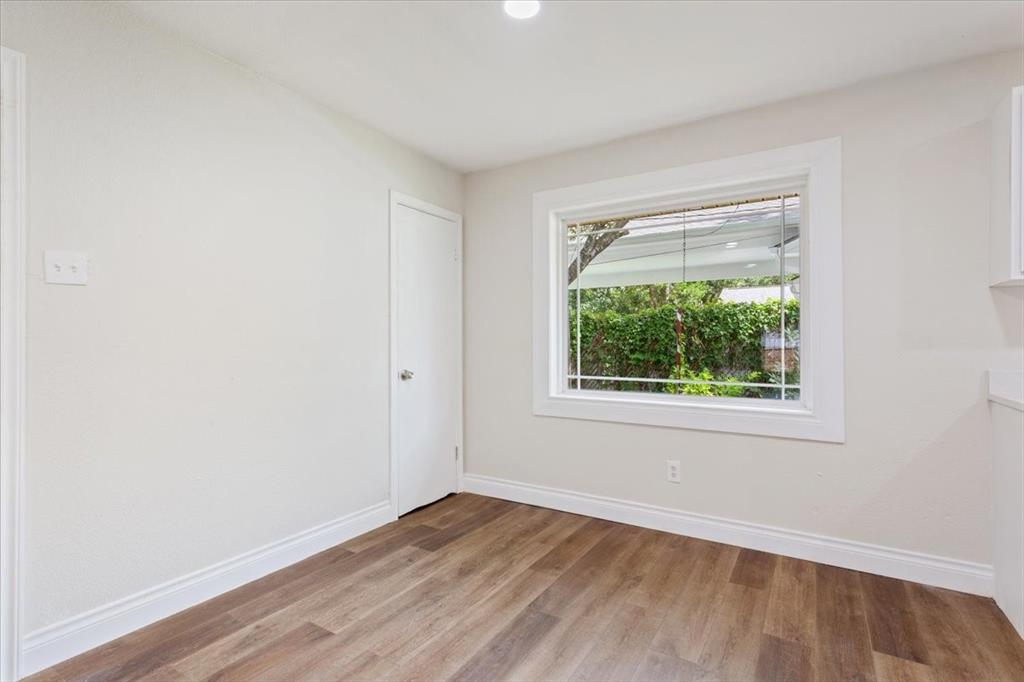 849 Arlington Drive Woodway, TX 76712 - Photo 17 of 33 an empty room with wooden floor and windows