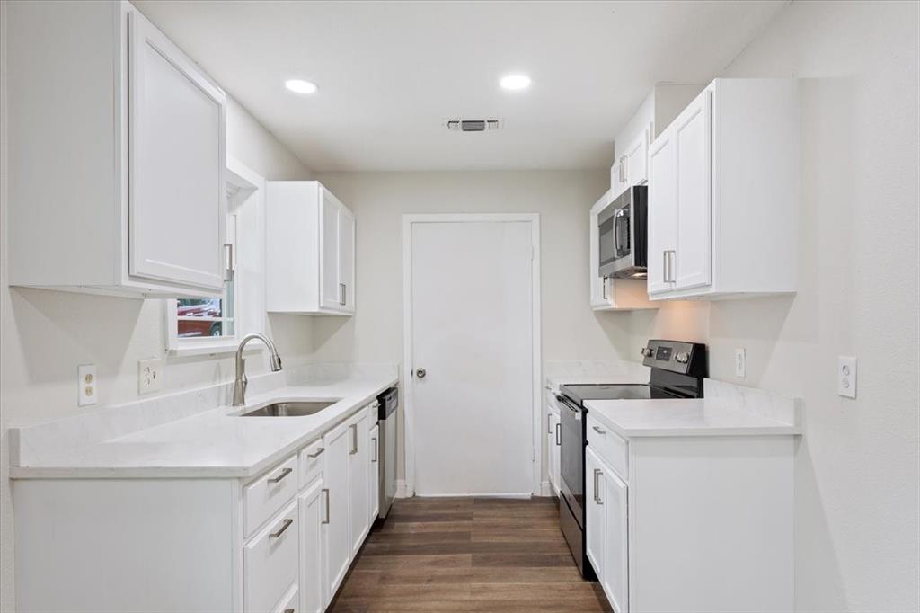 849 Arlington Drive Woodway, TX 76712 - Photo 18 of 33 a kitchen with a sink a stove and cabinets