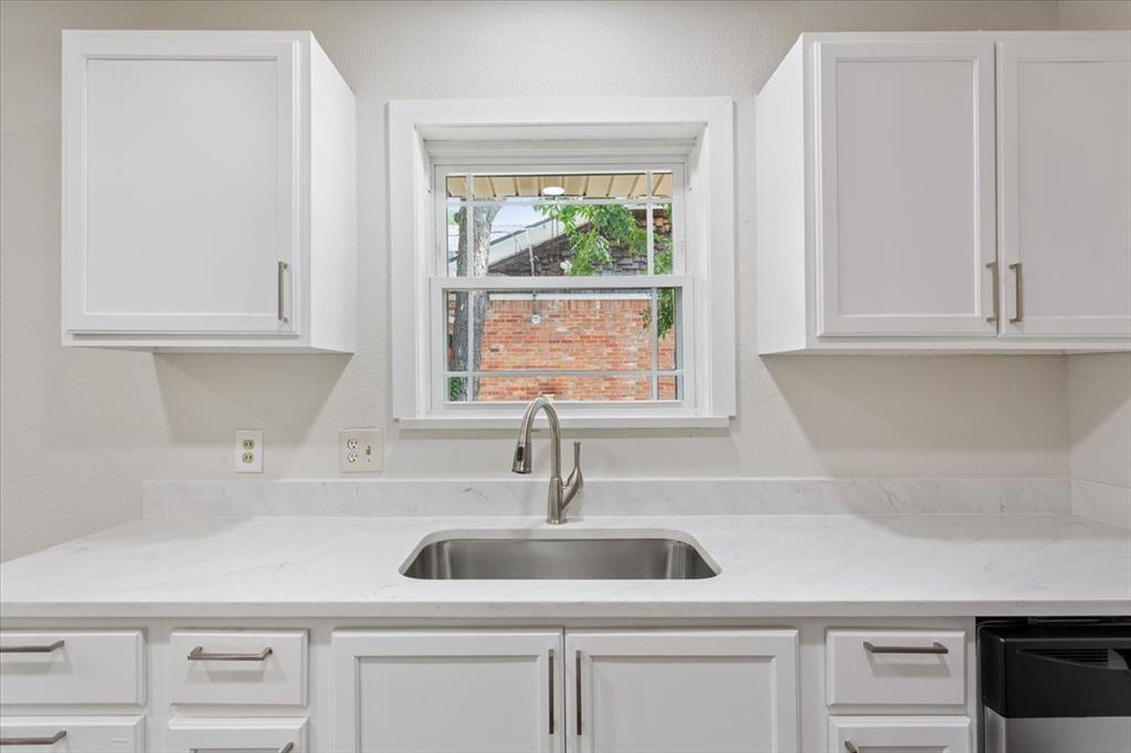 849 Arlington Drive Woodway, TX 76712 - Photo 20 of 33 a kitchen with appliances cabinets and a window