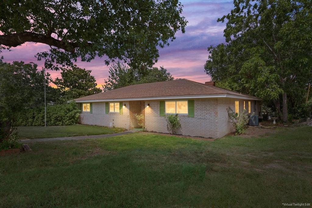849 Arlington Drive Woodway, TX 76712 - Photo 2 of 33 a front view of a house with yard and green space