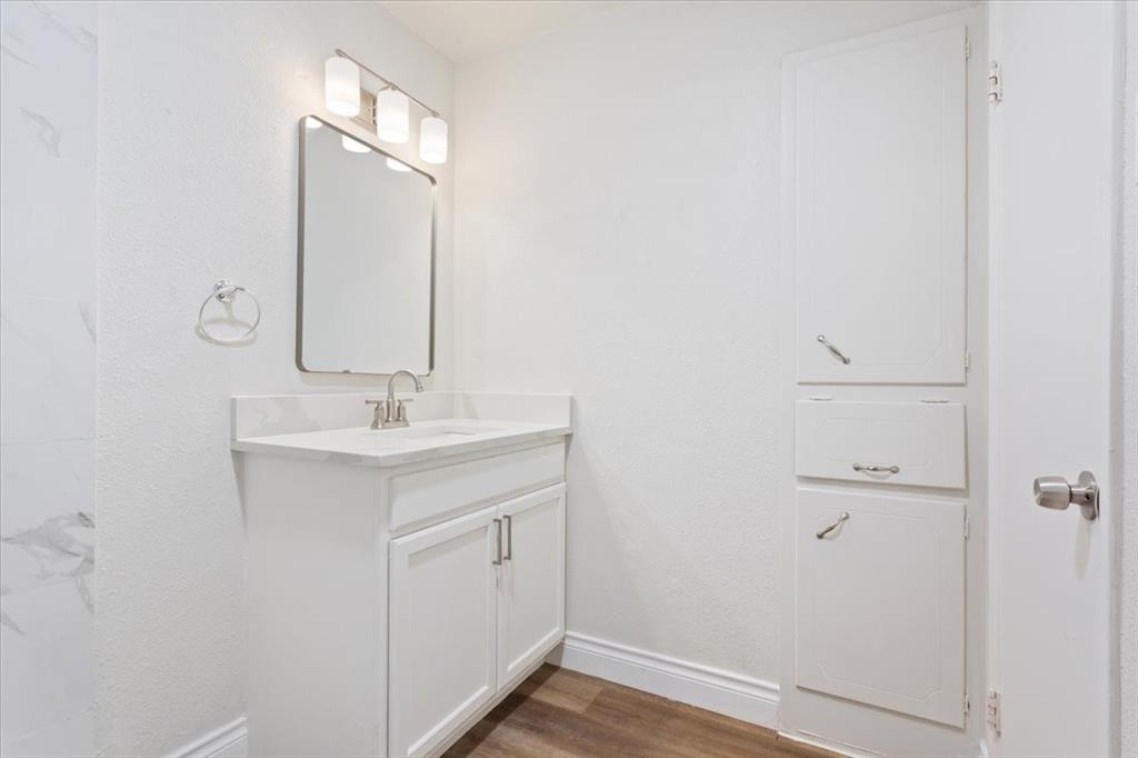 849 Arlington Drive Woodway, TX 76712 - Photo 22 of 33 a bathroom with a sink and a mirror