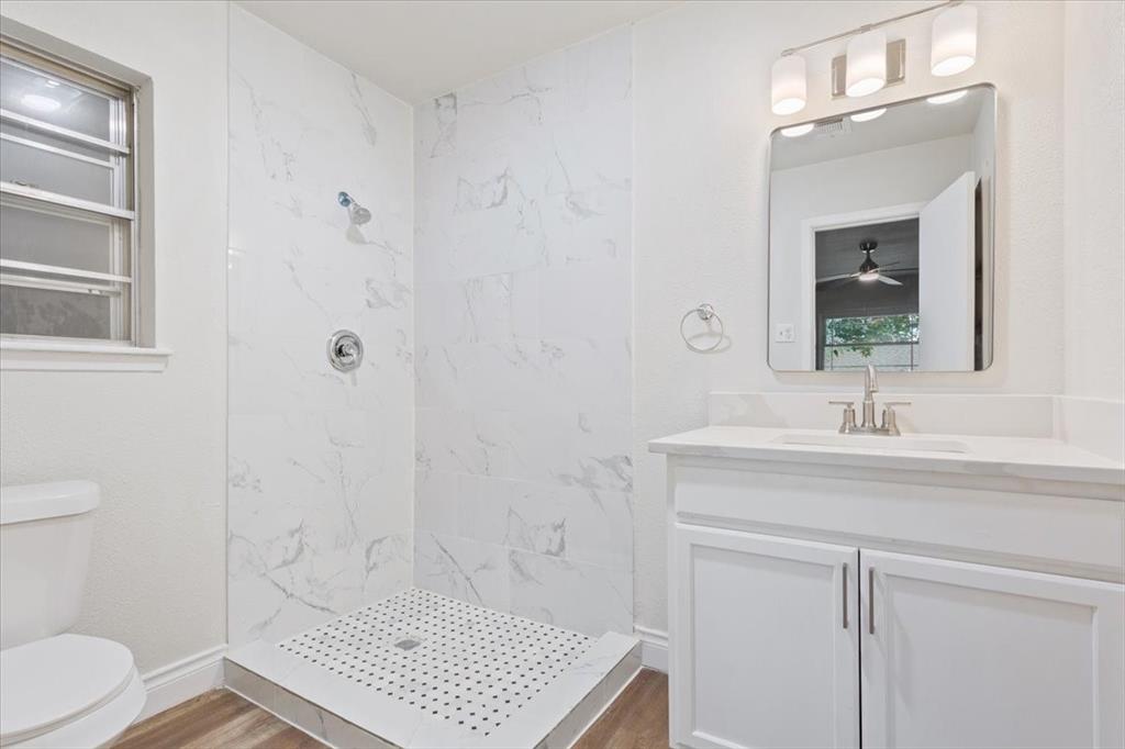 849 Arlington Drive Woodway, TX 76712 - Photo 23 of 33 a bathroom with a sink a toilet and a mirror