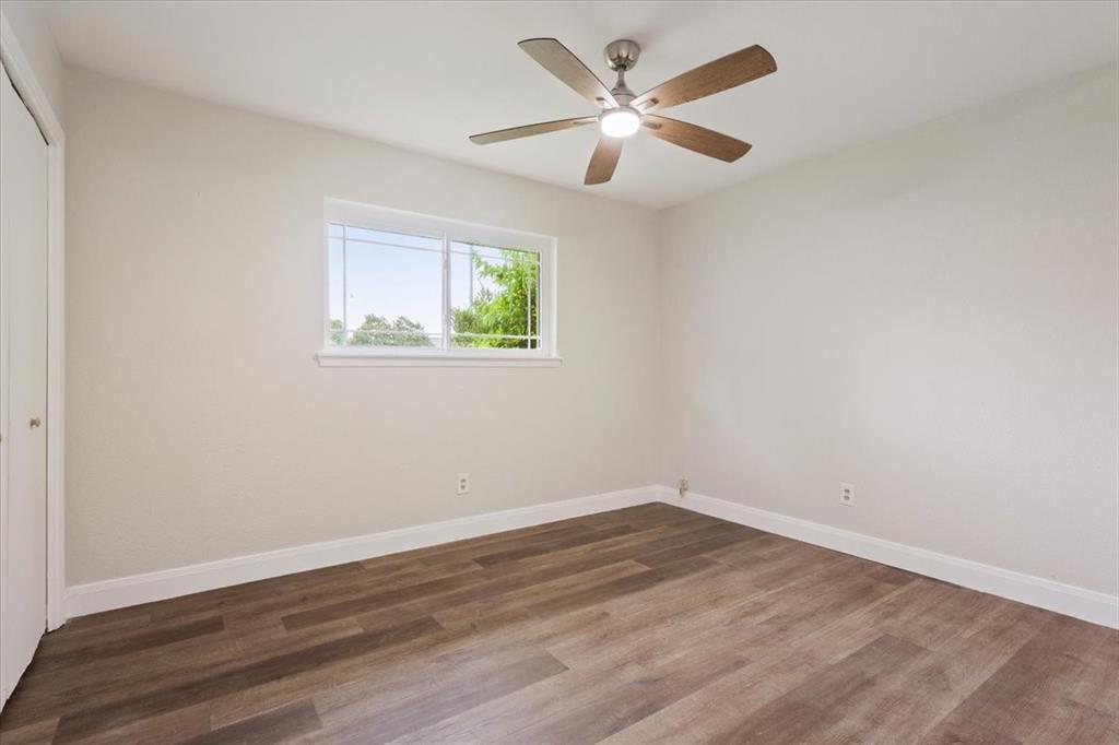 849 Arlington Drive Woodway, TX 76712 - Photo 24 of 33 a view of a room with wooden floor and window