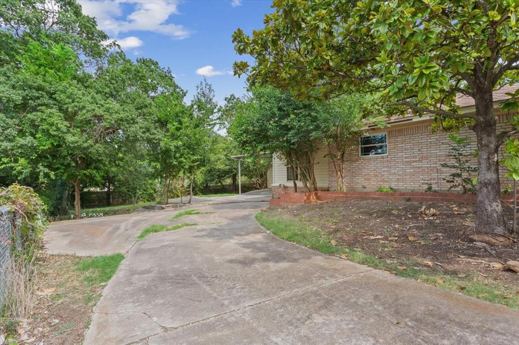 849 Arlington Drive Woodway, TX 76712 - Photo 31 of 33 a view of a tree in front of a house