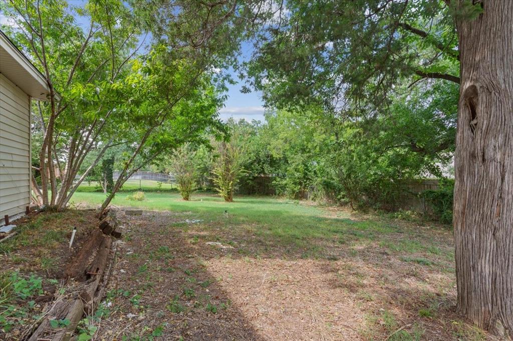 849 Arlington Drive Woodway, TX 76712 - Photo 33 of 33 a view of a yard with a tree