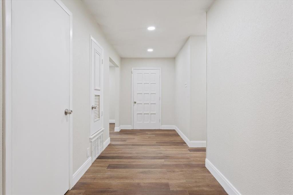 849 Arlington Drive Woodway, TX 76712 - Photo 8 of 33 a view of a hallway with wooden floor