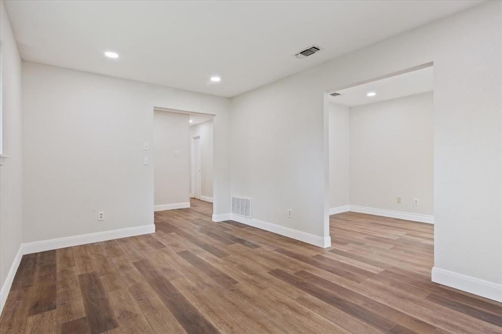 849 Arlington Drive Woodway, TX 76712 - Photo 9 of 33 a view of an empty room with wooden floor