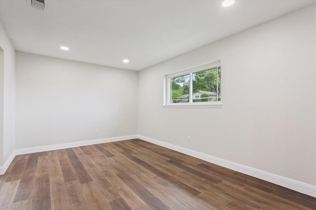 849 Arlington Drive Woodway, TX 76712 - Photo 10 of 33 a view of room with wooden floor and window