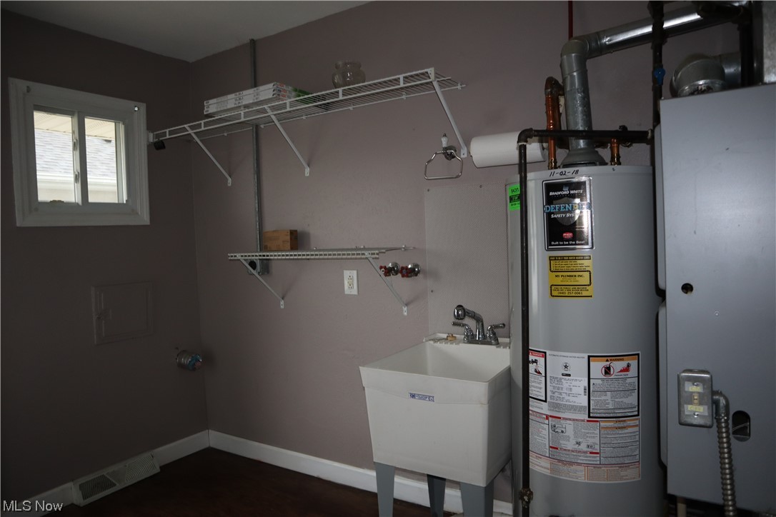 30073 Regent Road Wickliffe, OH 44092 - Photo 19 of 22 Utility room featuring gas water heater and sink