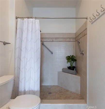 a bathroom with a toilet and shower