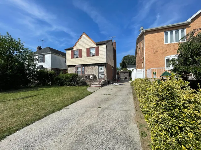 a front view of a house with a yard and porch