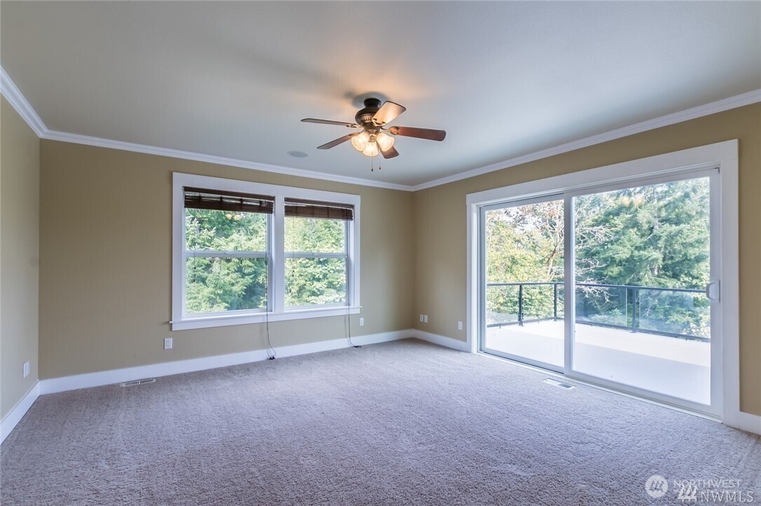 16619 249th Street East Orting, WA 98360 - Photo 14 of 21 a view of a big room with windows and chandelier fan