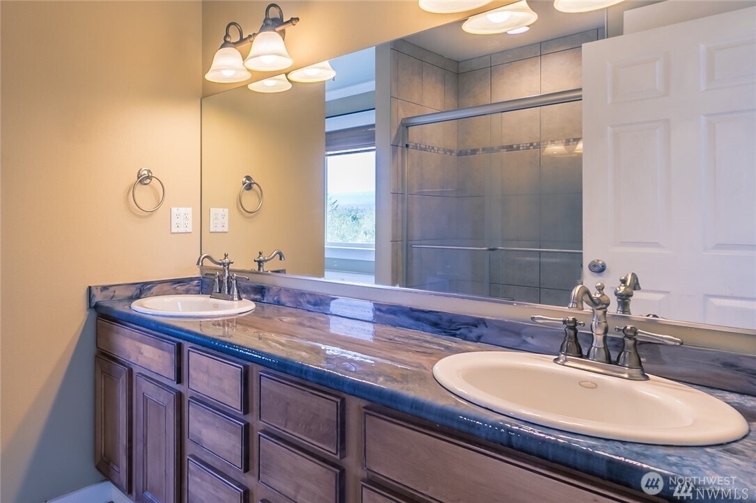 16619 249th Street East Orting, WA 98360 - Photo 16 of 21 a bathroom with a sink and a mirror
