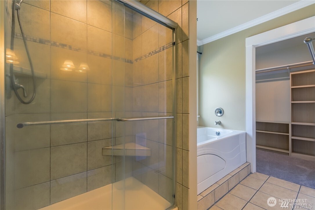 16619 249th Street East Orting, WA 98360 - Photo 17 of 21 a bathroom with a tub a sink and a shower
