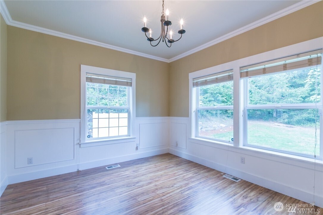 16619 249th Street East Orting, WA 98360 - Photo 6 of 21 a view of an empty room with wooden floor and a window