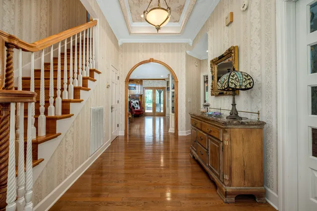 a large white kitchen with a large window and stainless steel appliances