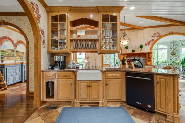 a view of a dining room with furniture a chandelier and a rug