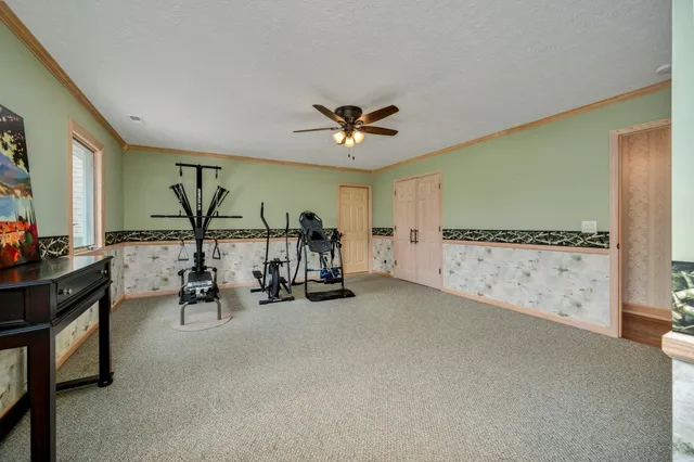 a view of a house with a big yard and large trees