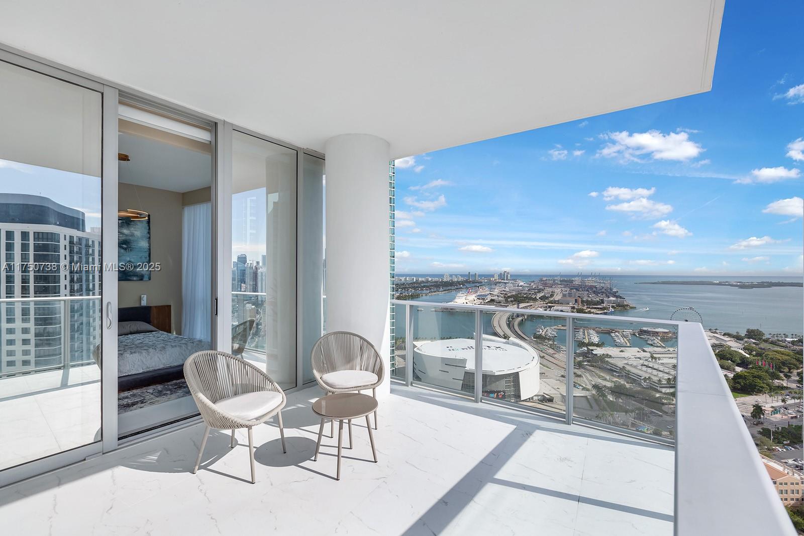 851 Northeast 1st Avenue, Unit 3611 Miami, FL 33132 - Photo 1 of 23 a view of a balcony dining table and chairs