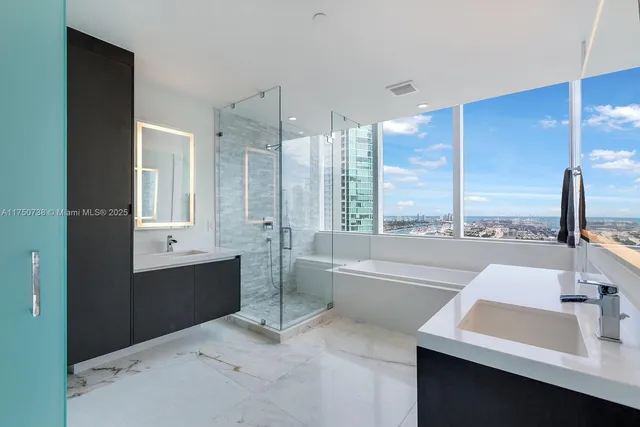 a bathroom with a tub sink and mirror