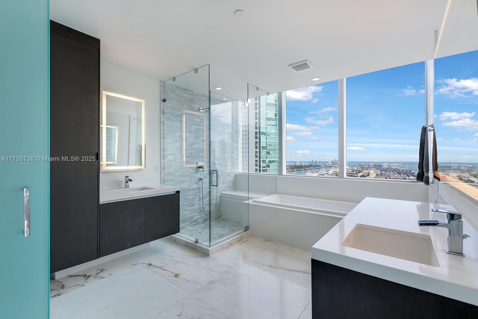 851 Northeast 1st Avenue, Unit 3611 Miami, FL 33132 - Photo 13 of 23 a bathroom with a tub sink and mirror