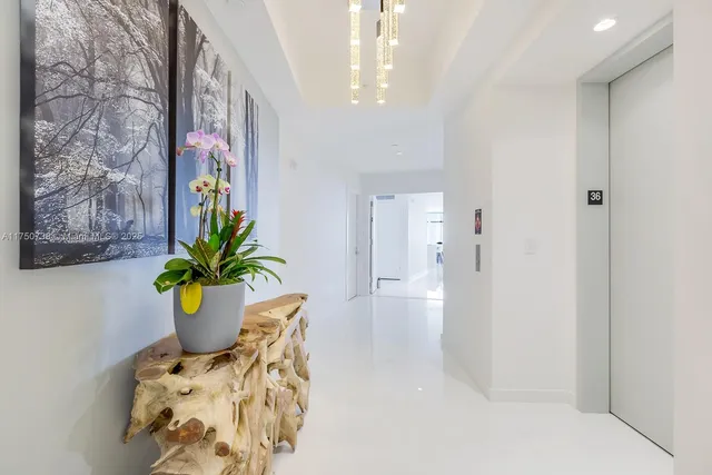 a dining room with furniture and potted plant