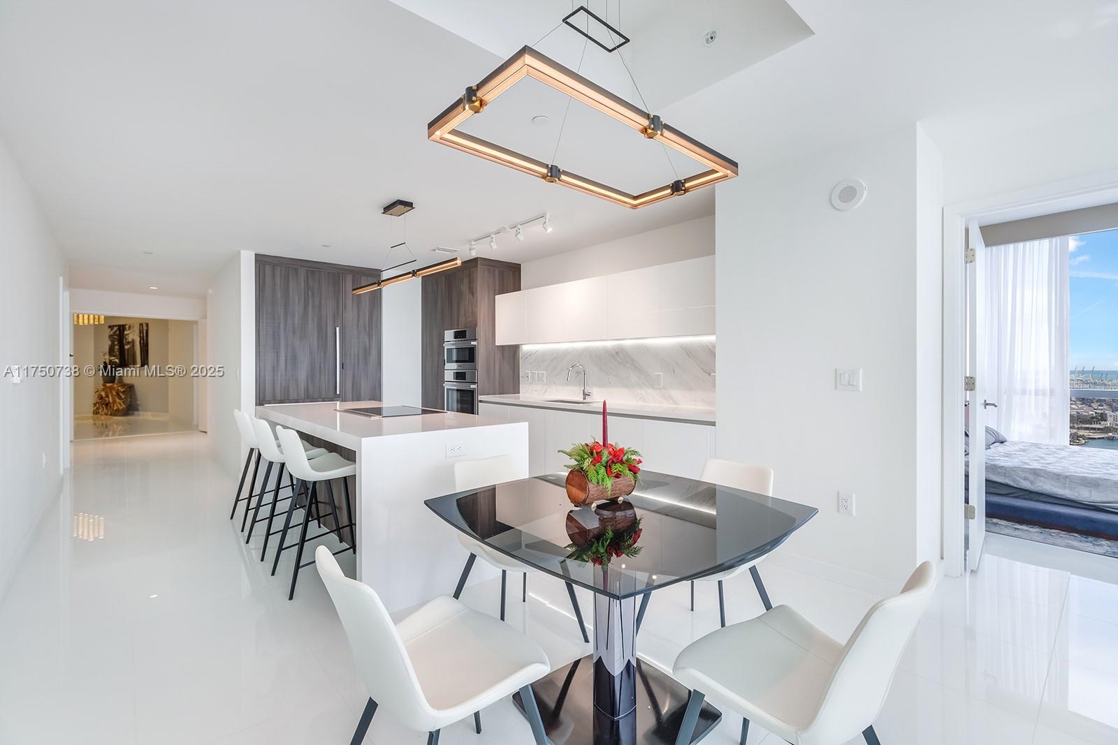 851 Northeast 1st Avenue, Unit 3611 Miami, FL 33132 - Photo 4 of 23 a view of a dining room with furniture and wooden floor