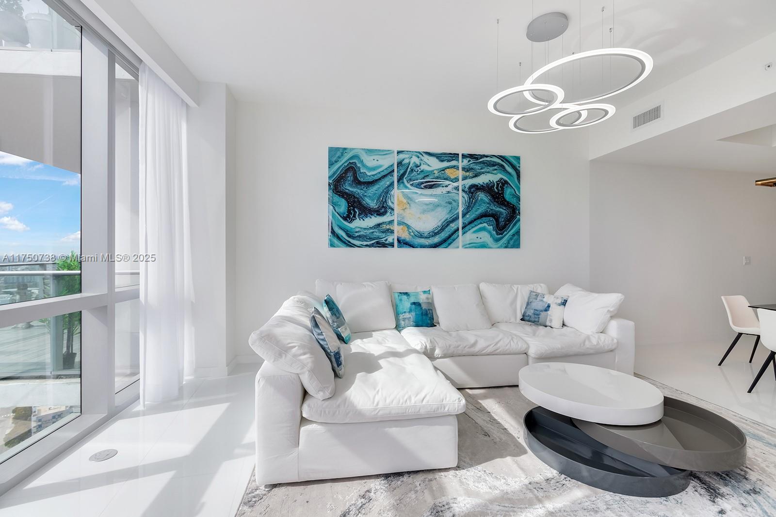 851 Northeast 1st Avenue, Unit 3611 Miami, FL 33132 - Photo 6 of 23 a living room with furniture and a large window