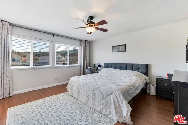 a bedroom with a large bed and a window