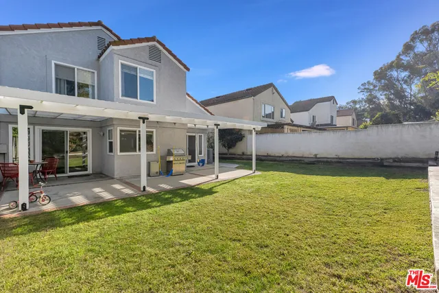 a view of a house with a yard balcony and sitting area
