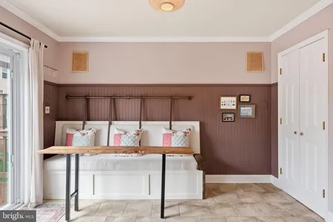 a living room with furniture and a wall painting