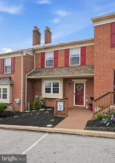 a front view of a brick house with a yard