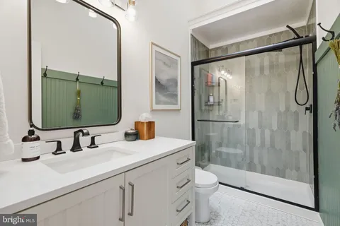 a view of a hallway with wooden floor and cabinet