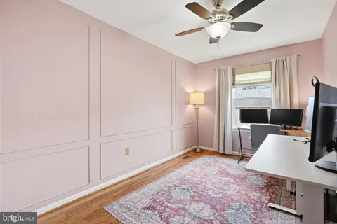 a view of a workspace with furniture and mirror