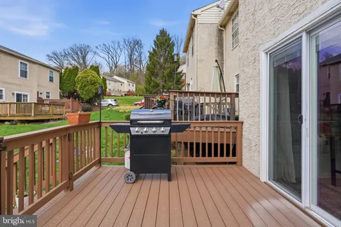 a view of a house with couches chairs and wooden fence