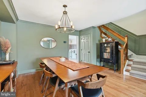 a view of a dining room with furniture wooden floor and chandelier