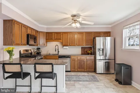 a kitchen with stainless steel appliances granite countertop a stove top oven a refrigerator a sink and dishwasher