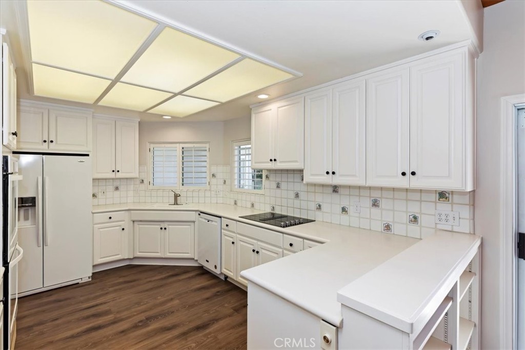1507 Weston Way Riverside, CA 92506 - Photo 17 of 55 a kitchen with white cabinets and white appliances
