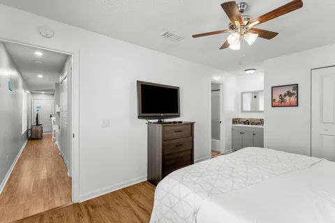 a bedroom with a bed and a flat screen tv