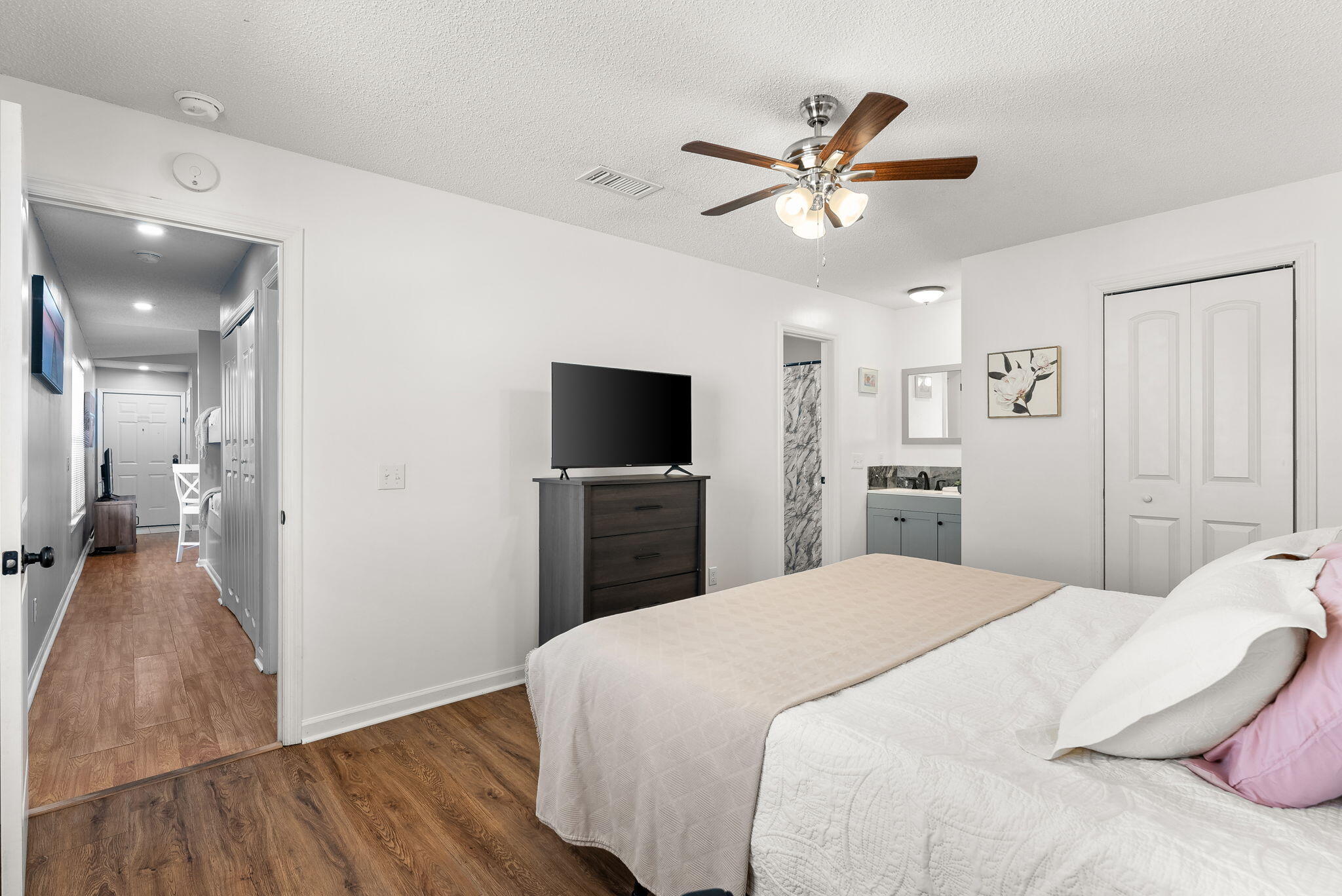 17462 Front Beach Road, Unit 73D Panama City Beach, FL 32413 - Photo 19 of 30 a bedroom with a bed and a chandelier