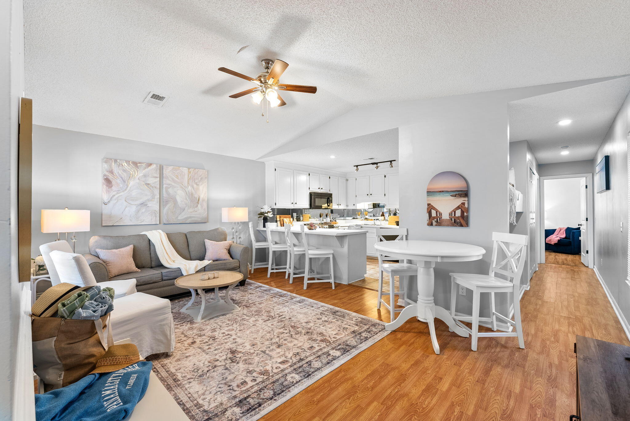 17462 Front Beach Road, Unit 73D Panama City Beach, FL 32413 - Photo 2 of 30 a living room with dining room and wooden floor