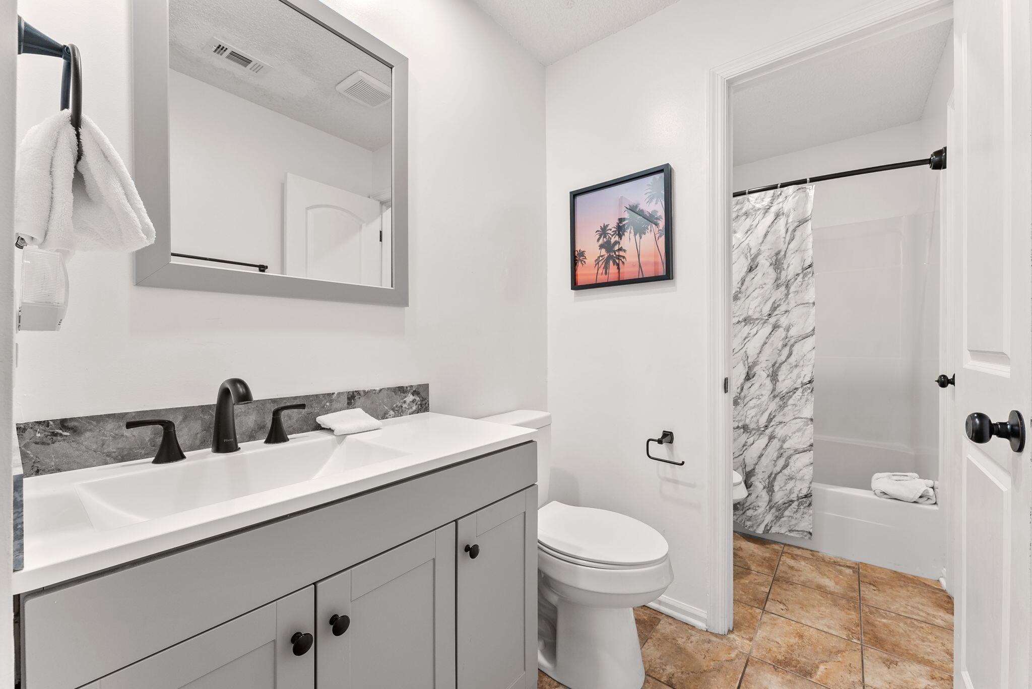 17462 Front Beach Road, Unit 73D Panama City Beach, FL 32413 - Photo 22 of 30 a bathroom with a sink a toilet and shower curtain