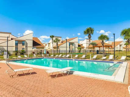 a view of swimming pool with outdoor seating and plants
