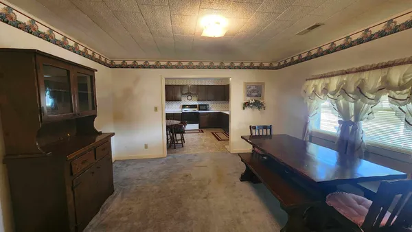 a living room with furniture and a ceiling fan