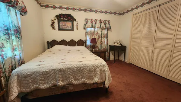 a spacious bedroom with a bed and a table