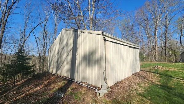 a view of a backyard with a white house