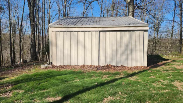 a yellow house with trees in front of it