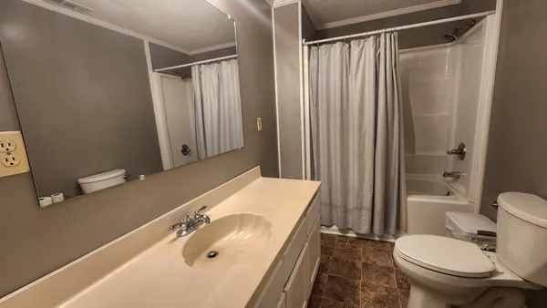 a kitchen with stainless steel appliances kitchen island granite countertop a sink stove and cabinets